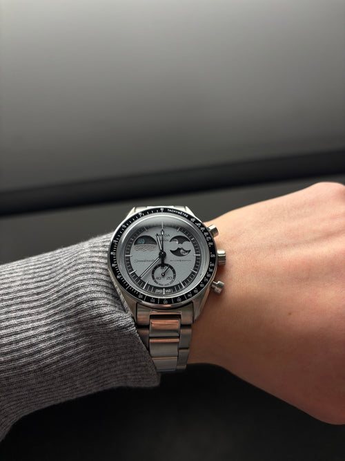Modded MoonSwatch with a white moonphase dial on the wrist