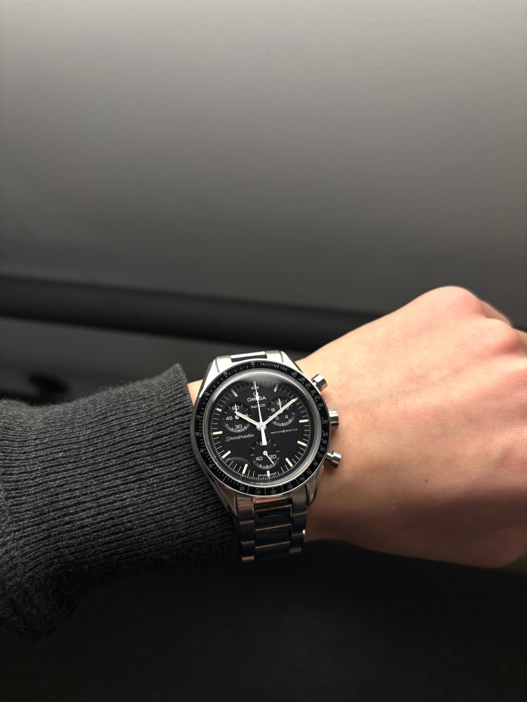 Modded MoonSwatch with a black dial on the wrist